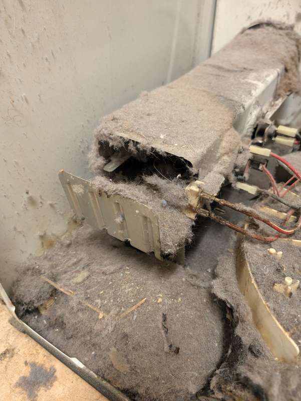 Heavy lint buildup inside a dryer heater box — a no-heat and fire risk — DFW