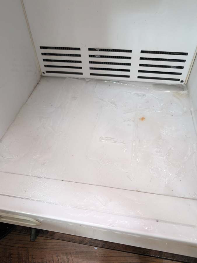 Ice buildup on Viking freezer floor from a blocked defrost drain