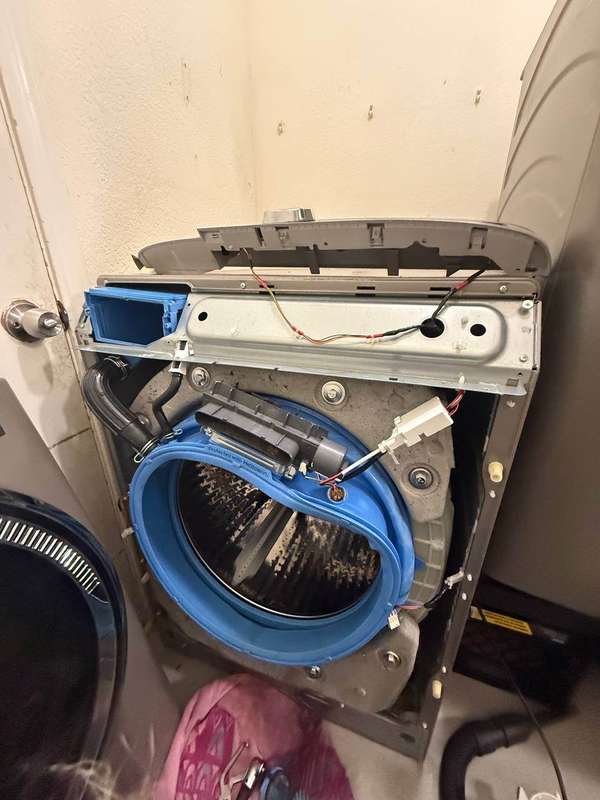 GE front-load washer disassembled for drum bearing access — Done Right Appliance Repair